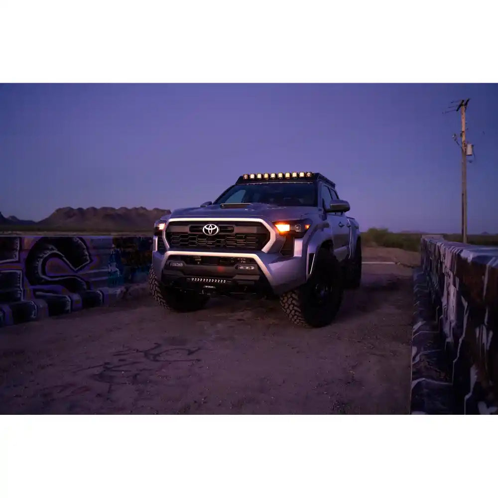 2024 Tacoma at night with pod lights lit in Rago roof rack