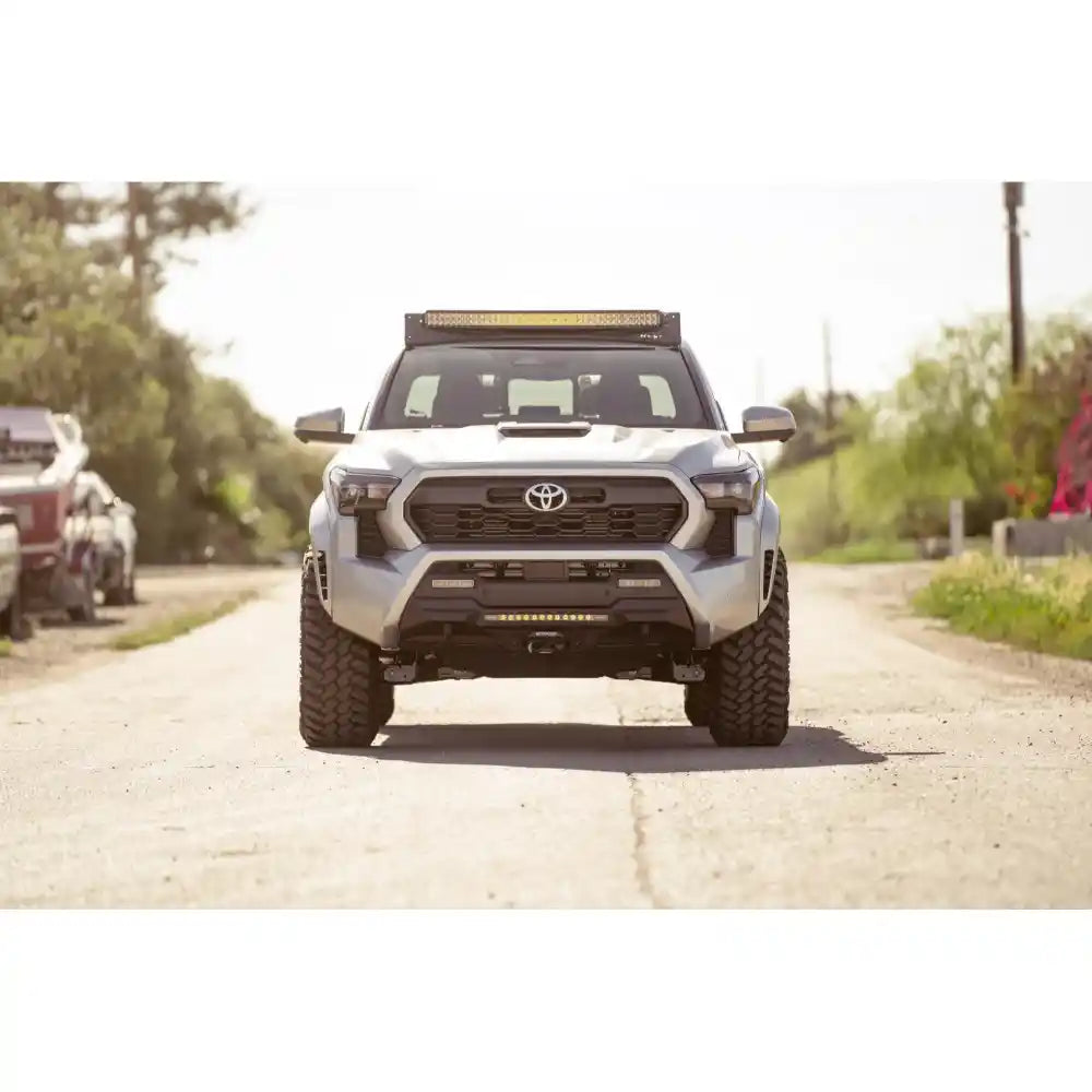 4th Gen Tacoma with Rago light pocket rack on road, front view