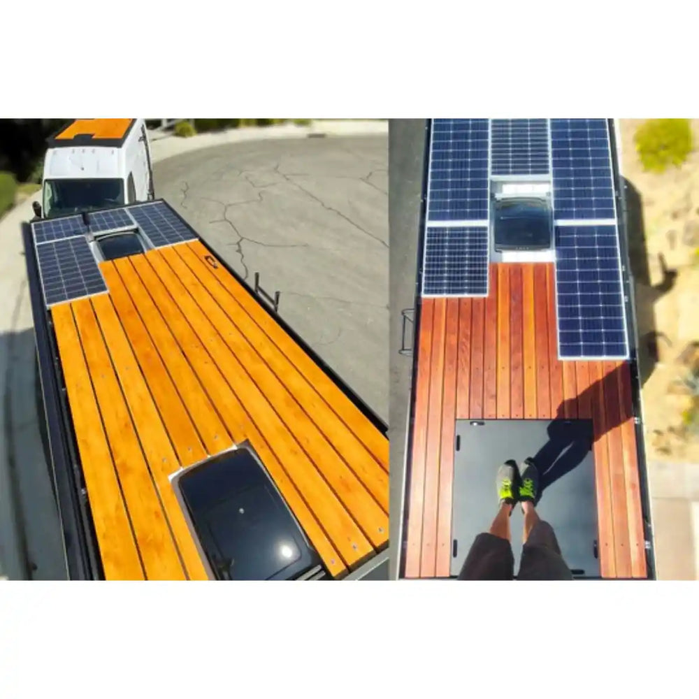 Person standing on the roof of the Promaster with Wooden bed and solar panels