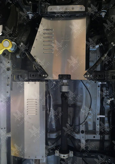 Under-vehicle view of the MillerCat V1 Cat Shield installed on a Toyota Tacoma 2.7L RWD, highlighting its fitment and coverage area.