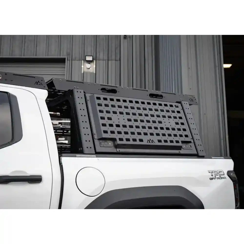 Truck bed with a black storage system on a white truck