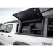 Truck bed with open storage compartment and 'TRD' branding on a white truck.