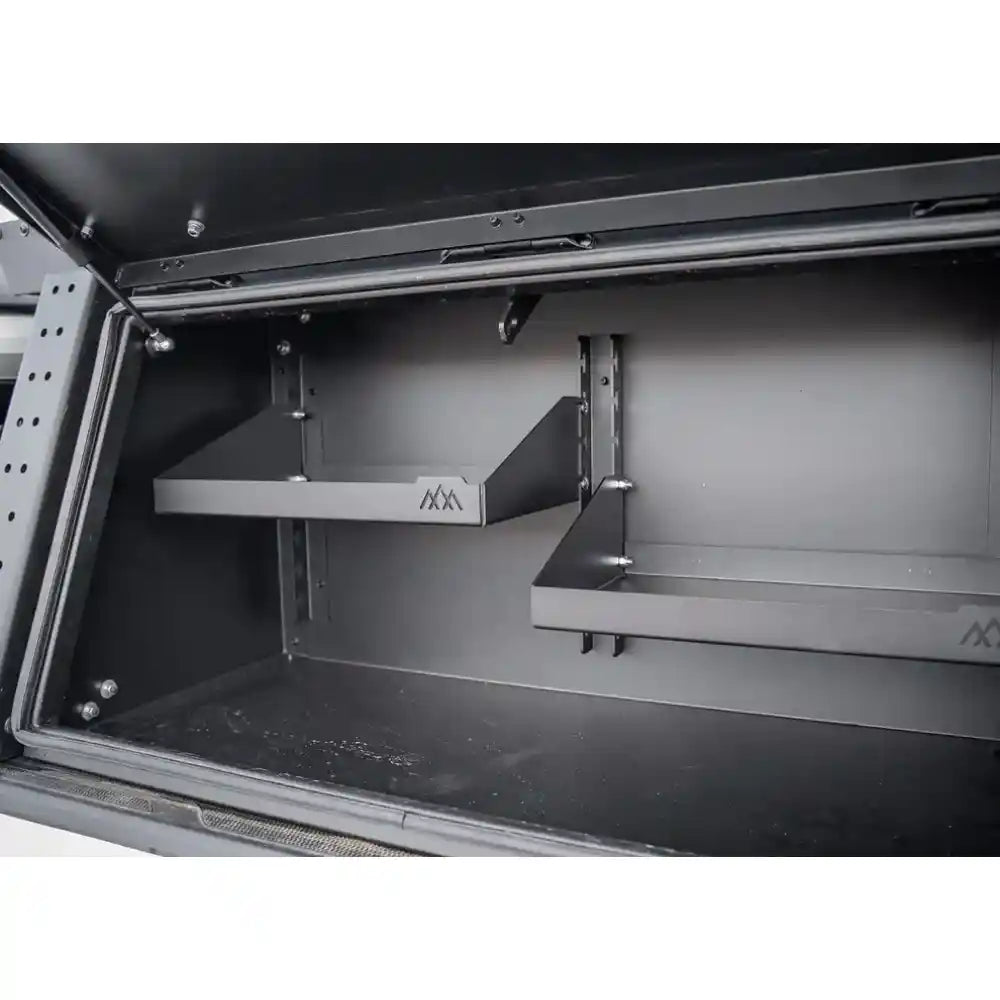 Metal storage shelf system with multiple shelves inside a vehicle compartment.