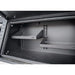 Metal storage shelf system with multiple shelves inside a vehicle compartment.