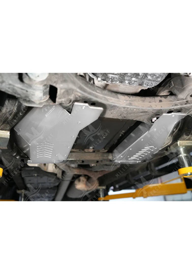 Close-up of a vehicle's undercarriage with a metal CAT guard