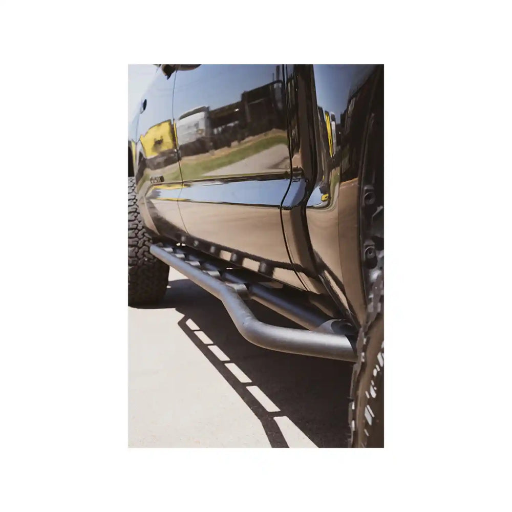 Close-up of a vehicle's side step bar on a white background