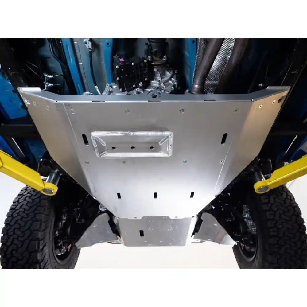 Undercarriage skid plates on a tacoma with visible suspension components